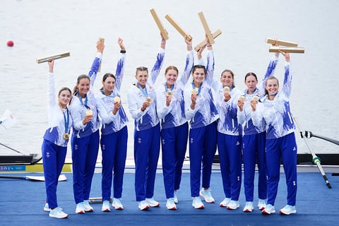 Women's eight rowing final: Romania's team pose after winning gold 